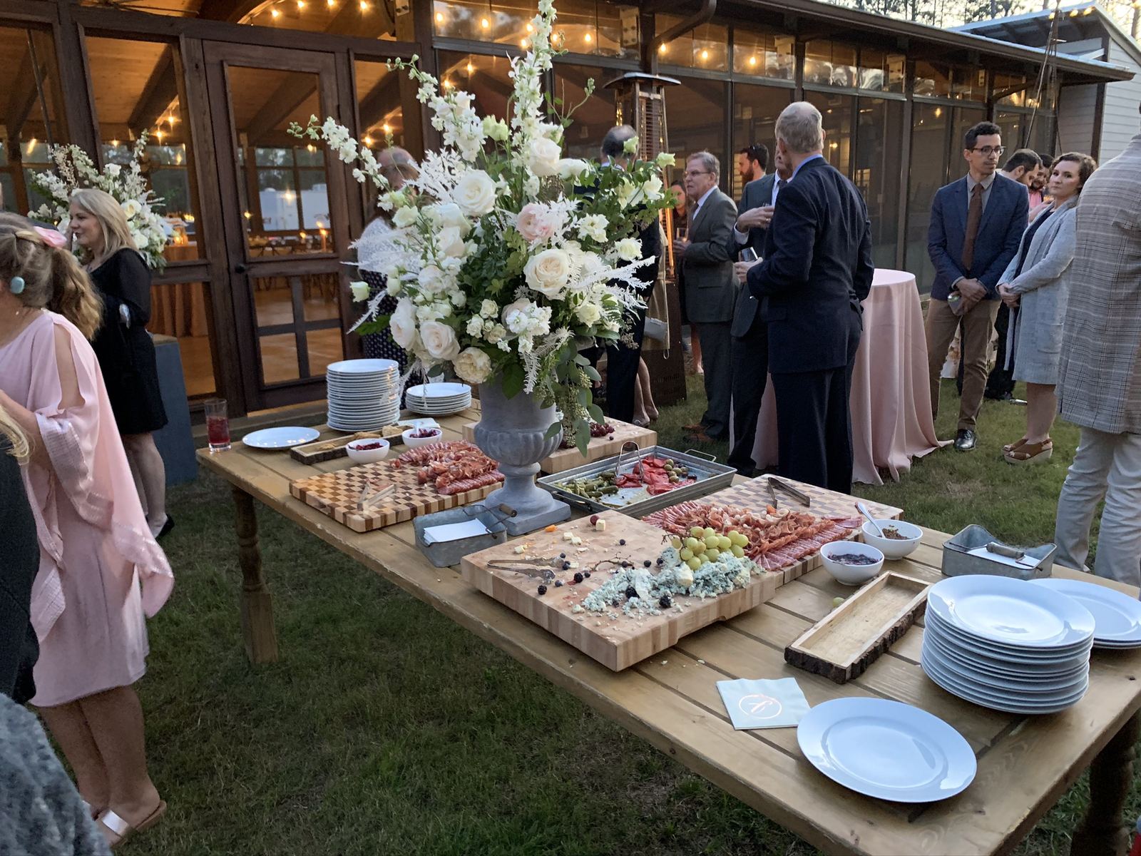 Outdoor cocktail and grazing table setup beside the pavilion