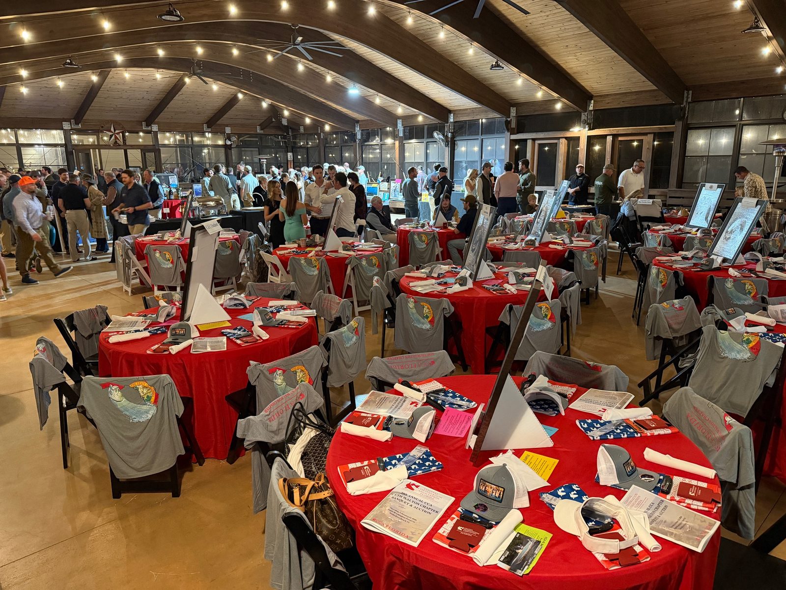 A full gala reception with round tables inside the Point Preserve pavilion