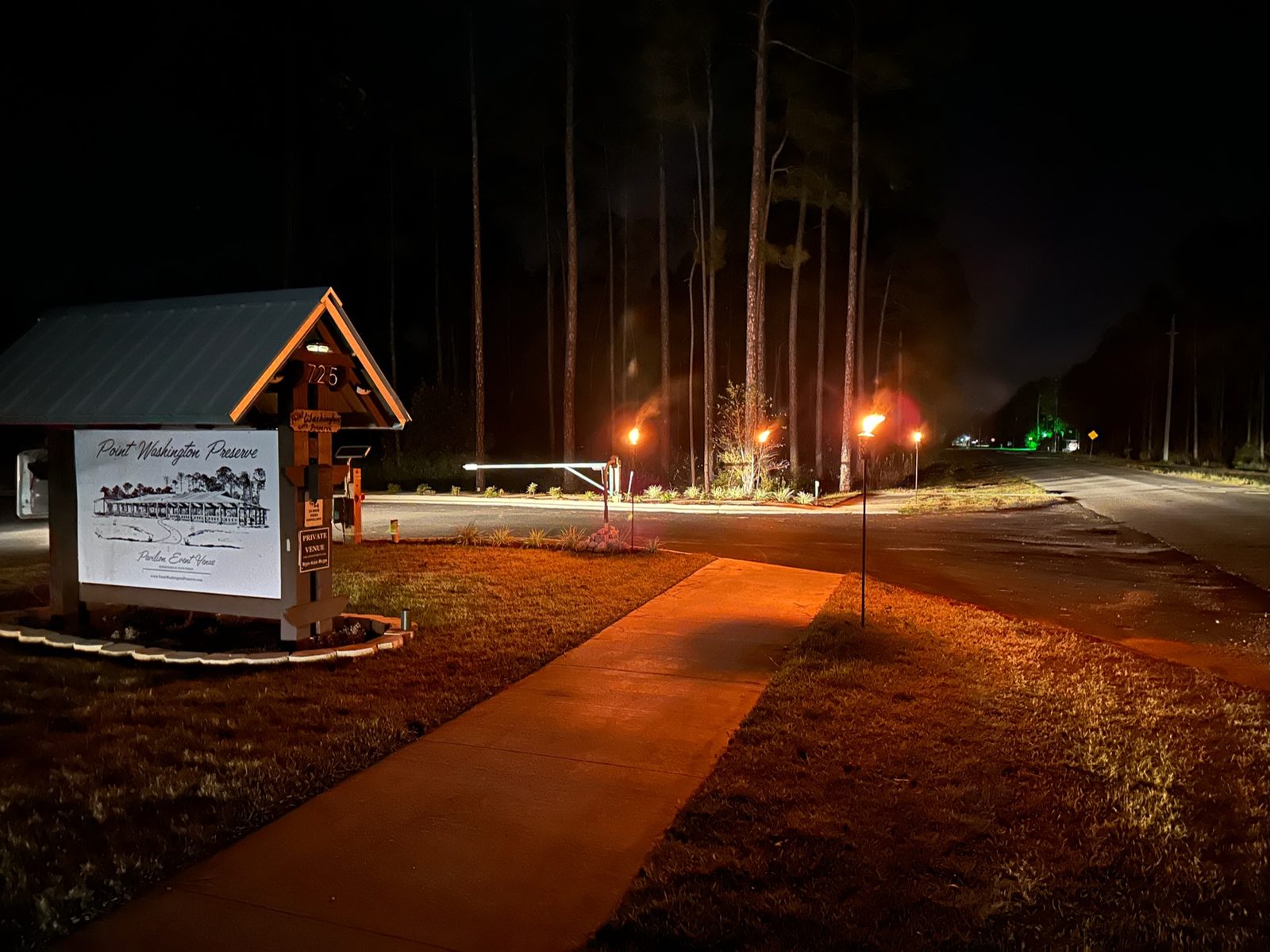 Guest arrival cabin lit warmly against the dark grounds at night