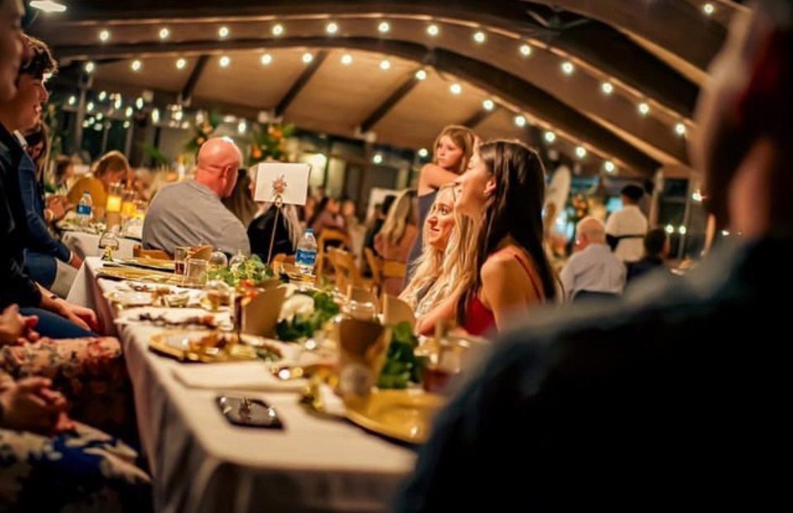 Artfully arranged grazing board with candles and florals under the pavilion